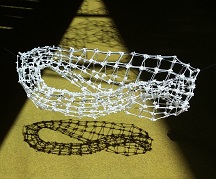 Floating Grid of Klein bottle made of cable ties and its shadow